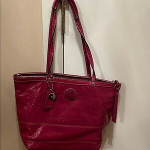 Chic Hot pink Coach patent leather medium sized handbag.